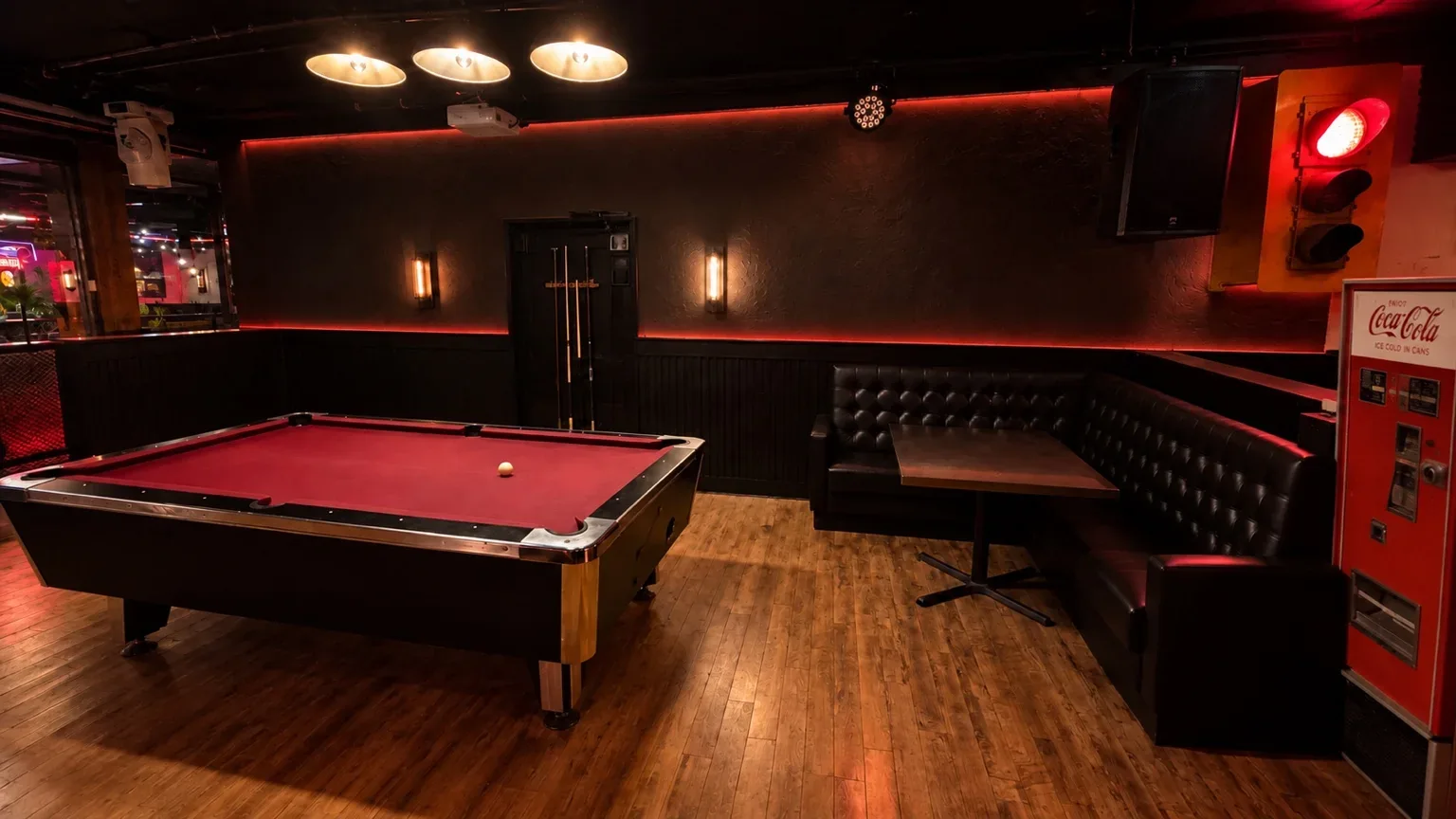 Fratelli’s lounge, with warm wood floors, leather seating and a pool table